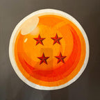A circular Dragon Ball rug featuring the classic orange and yellow design with four red stars and a white border, photographed on a dark gray floor.