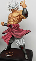 A detailed anime figurine of a muscular male character with spiky white hair, wearing a pink sash, white pants, and dark arm/leg guards, posed on a display base next to another collectible figure.
